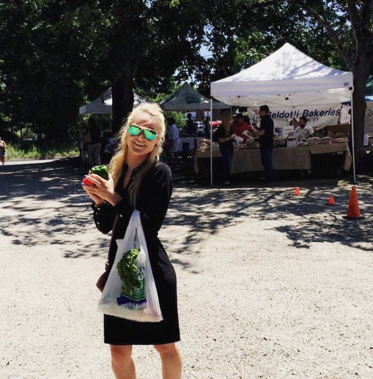 One of the Marketing team members, Erica Driver with some fresh fruit from a local farm. 